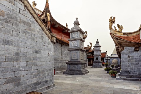 Inner courtyard with grey stone walls in traditional Asian architecture and decorated roofs, The