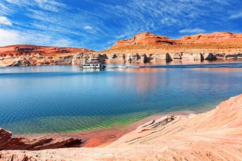 Lake Powell. The coast is cut by narrow canyons. USA. The smooth emerald water of the lake