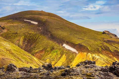 Incredible shades of rhyolitic mountains - yellow, orange, green and blue. Summer volcanic tundra.