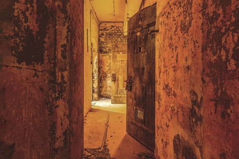 Dilapidated corridor with open doors and rusty walls, gloomy and mysterious, Prison H11, Lost