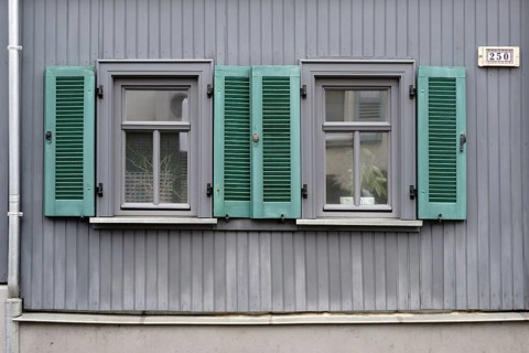 A terraced house with nostalgic wooden shutters and plank walls