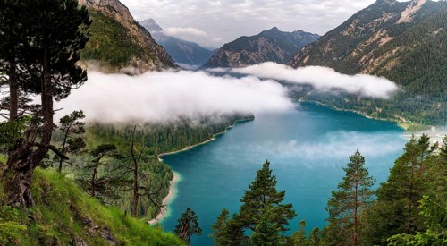 Lake Plansee near Reutte in Tyrol with low clouds over the lake