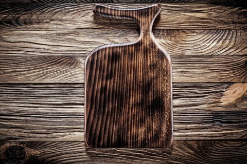 Wooden kitchen utencil cutting board on vintage wood