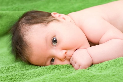 A one month old caucasian brunette baby
