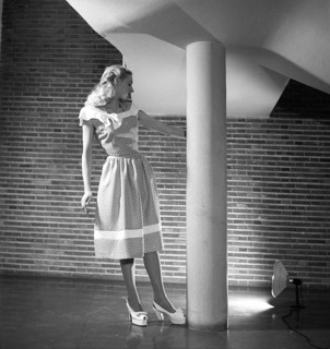 Fashion 1946, a young blonde female model dressed in the fashion of the year. Her sleeveless dress