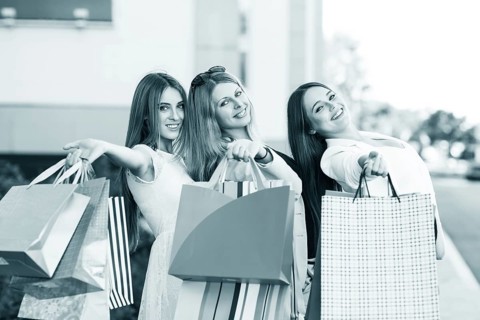 Three young women posing on a summer day in the city
