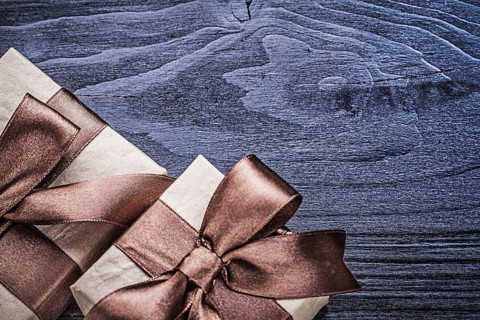 Packed gift boxes on wooden board holidays concept