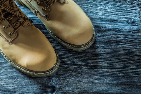 Safety lace boots on wooden board