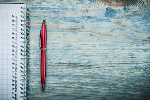 Blank note-books biro pen on wooden board copy space office concept