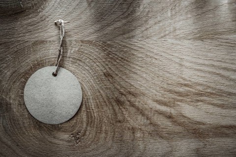 Round price tag on wooden board
