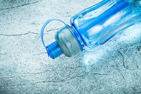 Water bottle for doing sports on silver background fitness concept