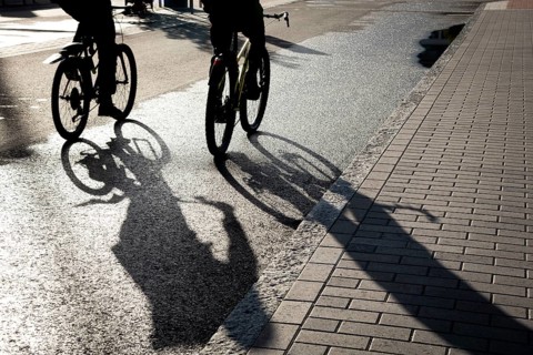 Silhouette of unrecognised people cycling outdoor in the morning. People exercising. Healthy