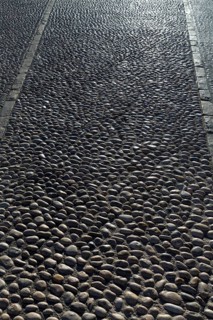 Rolling stones pavement soil texture in Altea Alicante mediterranean village of Spain