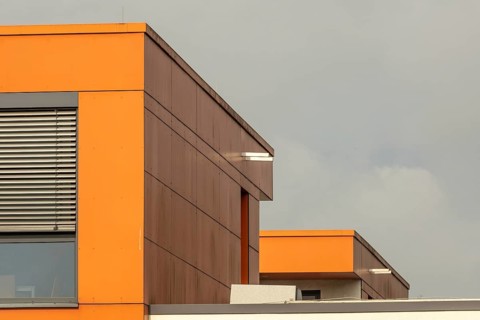 Ultra modern office building with windows and orange walls