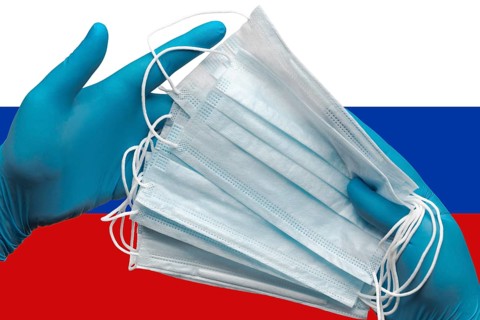 Doctor holding face masks in hands surgical blue gloves on background national flag of Russia.