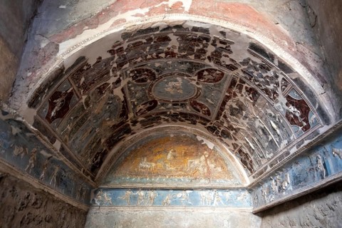 POMPEII, ITALY, MAY 04, 2022, Beautiful colorful stucco in a room niche of a Pompeian villa,