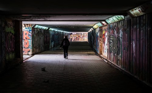 Freattyda, Athens, Greece, 12 28 2019 Torusit walking under a dark underpass tunnel, Europe