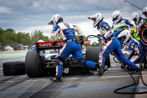 LINUS LUNDQVIST (R) (8) of Stockholm, Sweden comes down pit road for service during the XPEL Grand
