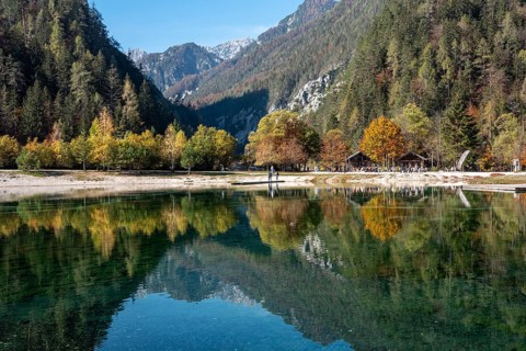 Scenic autumn forest at Crystal Lake in the Julian Alps, Slovenia, Europe