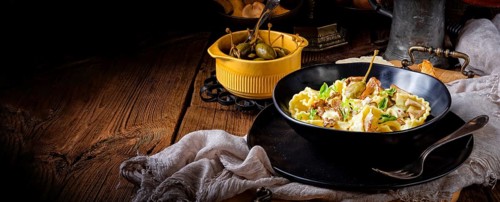 Reginette noodles in cream sauce with fresh chanterelles and capers