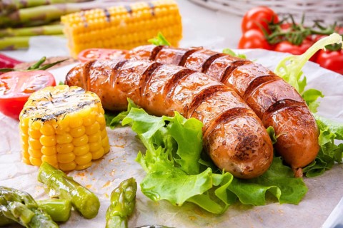 Grilled krakauer sausage with boiled corn and green salad