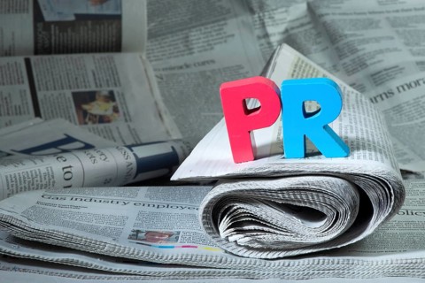 Word PR on newspaper. Wooden letters