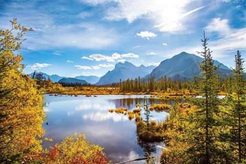 Grandiose landscape in the Rocky Mountains of Canada. Lake Vermillon among the yellow fall foliage