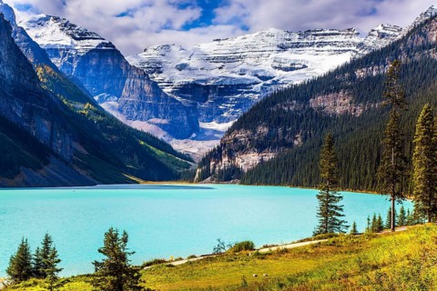 Travel to the Rocky Mountains of Canada. The lake with azure water is surrounded by mountains and