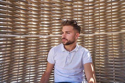 Young beard man relaxed in a beach hammock