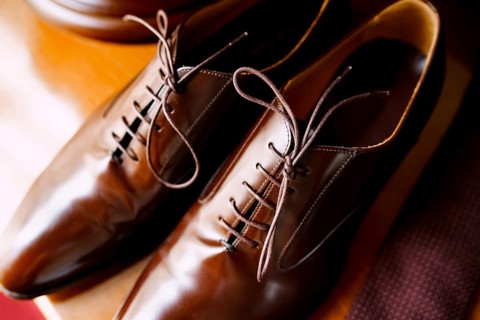 Men's brown shoes made of genuine leather with laces close-up.