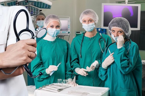 Doctor holding stethoscope over surgeons team prepare to operation