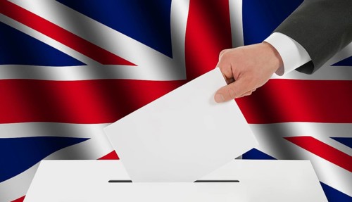 The British flag and the hand with the bulletin about the ballot box