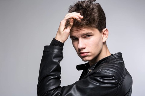 Hair care, health and wellness concept. portrait Of Confident, Charismatic man Touches With Hand,