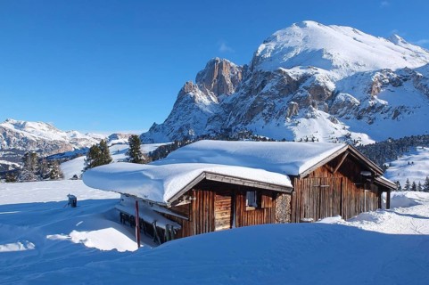 Wooden challet in the Dolomites mountain in winter