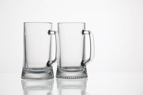 Empty glasses of beer on the glass desk