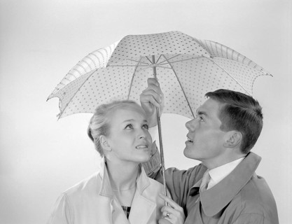1960s couple. A happy smiling couple is standing under an umbrella. Sweden 1960 Conard ref 4254