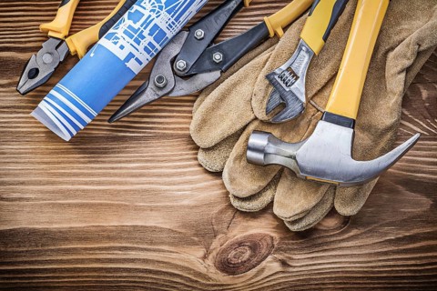 Blueprint protective gloves claw hammer gripping tongs tin snips adjustable spanner on wooden board