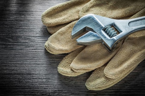 Adjustable tensioner protective gloves on wooden board