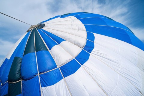 Blue Balloon in the blue cloudy sky