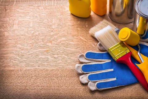 Work tools on protective gloves paint cans and bottles maintenance concept