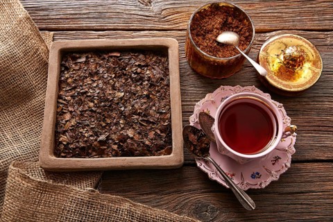 Bancha tea served pink vintage cup on wooden table board