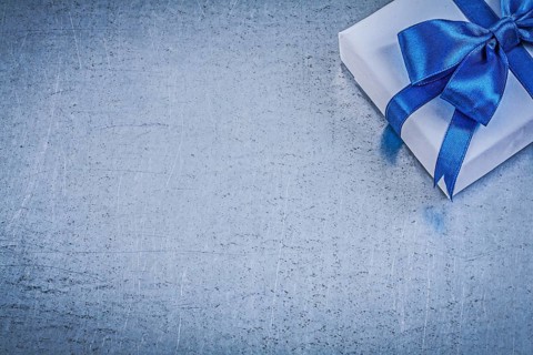 Present box blue bow on metallic background copyspace celebrations concept