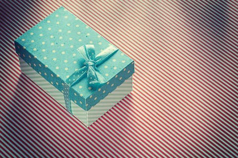 Present box on stripy tablecloth celebrations concept