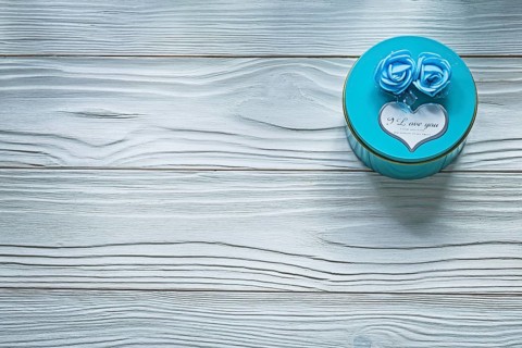 Round blue present box on wooden board celebrations concept