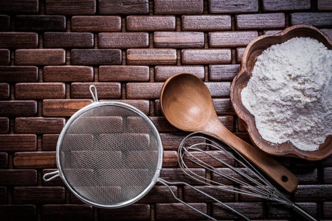 Wooden spoon bowl with flower egg whisk and sieve