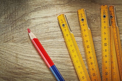 Wooden meter pencil on wood board construction concept