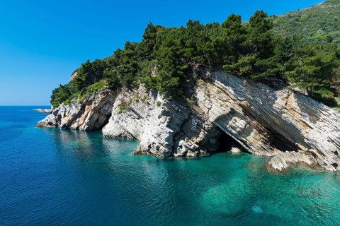 Rock structure, blue water and sky at the Adriatic coast