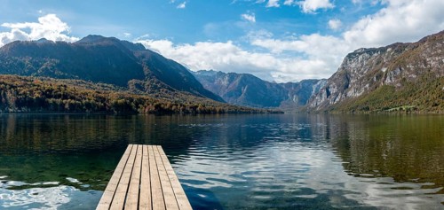 Scenic view of a small wooden jetty at lake Bohinj in the Triglav National Park, The Julian Alps,