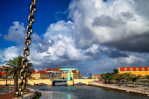 A view of a bridge in willemstad on curacao with blue sky and beautiful clouds