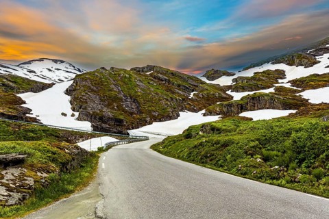 The road to Lake Djupvatnet. The mountains are covered with freshly fallen snow. Summer trip to